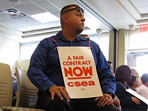 A classified employee shows his support for a fair contract at the Tuesday, July 21 Board of Trustees meeting. Photo by Aaron Castrejon.