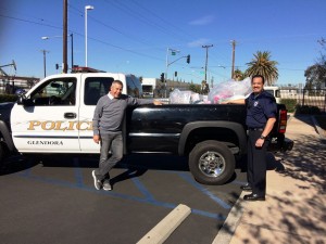 Sit 'n Sleep's Nelson Bercier and Glendora Auxiliary Officer Ed Saiza stand before a Glendora Police truck overflowing with donations. Photo courtesy of the Glendora Police Department.