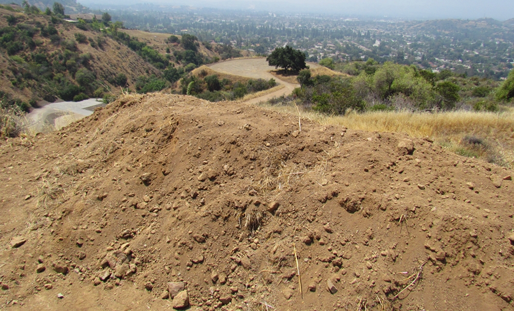 A large mound of dirt almost four feet high was pushed off near Gordon Ranch Road, while a dirt lot seen in the distance was one of a few possibly illegally graded. Photo by Aaron Castrejon.