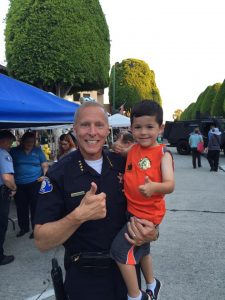 Chief Staab with a young resident enjoying last year's National Night Out Against Crime event. *Photo courtesy of Glendora PD Facebook page