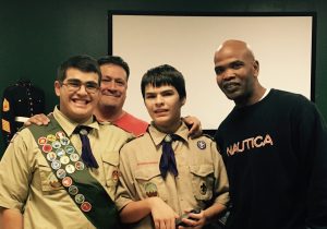 Troop 446 representatives James Bourbois, his father Robert and another troop member present 1st Sergeant Quavis Shuler with the donated toys 