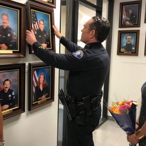 Lieutenant Strong hangs his photo during his retirement ceremony on Thursday, June 29, 2017. 
