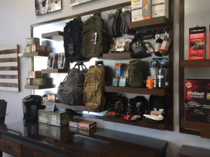 Wall of custom built emergency readiness kits they sell in different sizes